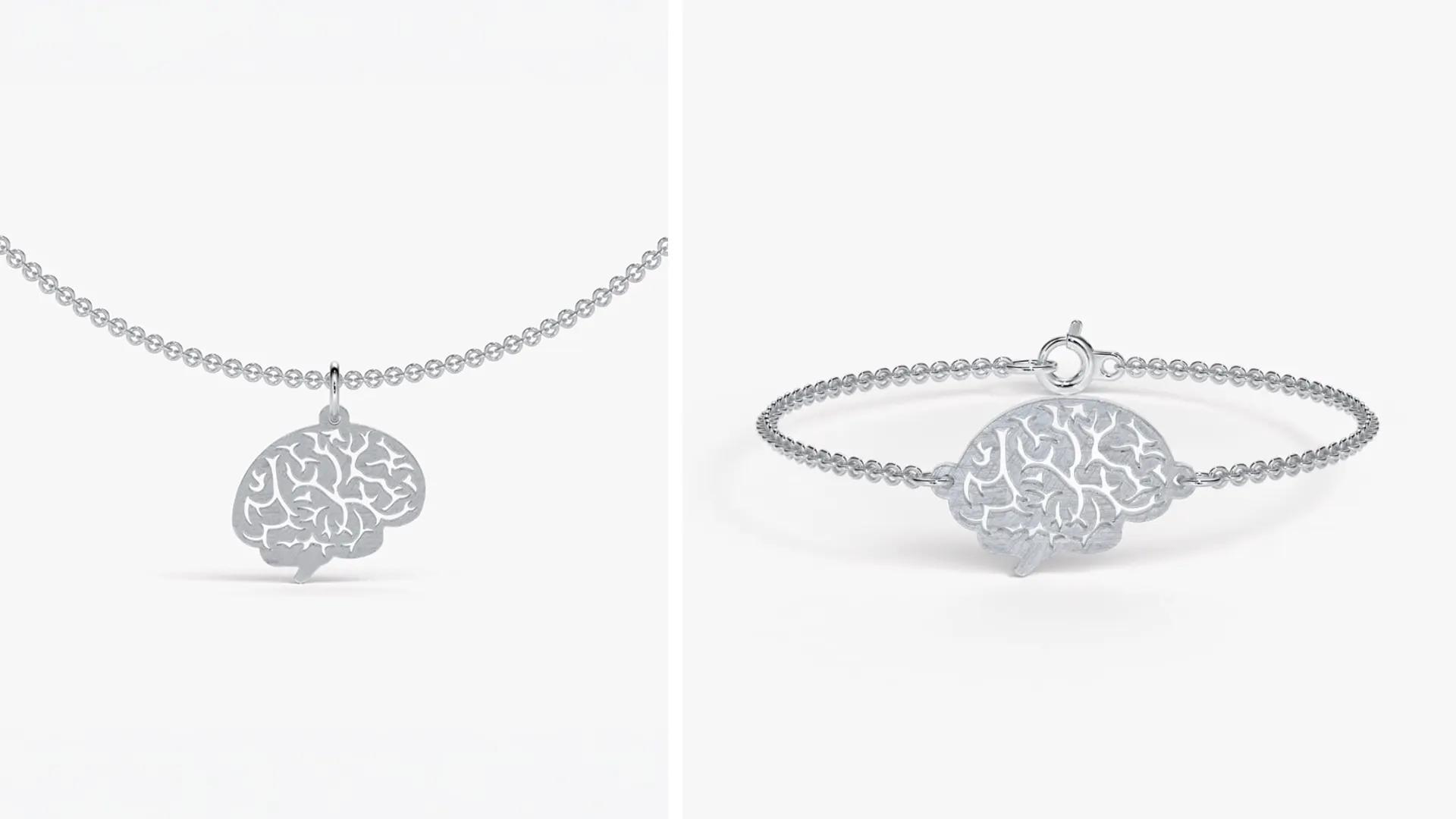 Bild på en kedja och armband i silver med ett hängsmycke som ser ut som en hjärna.